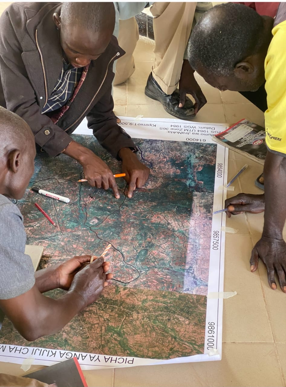 Reviewing village land use map in the field